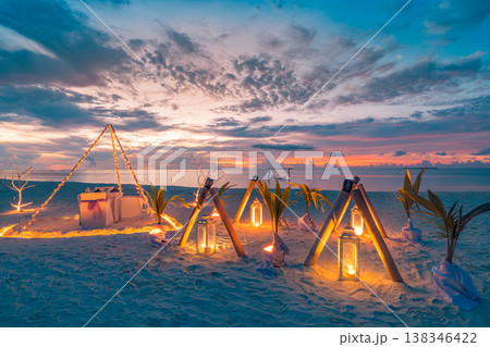 Romantic beach dinner with candles and artistic table setting, ocean view summer honeymoon wedding anniversary outdoor design background 138346422