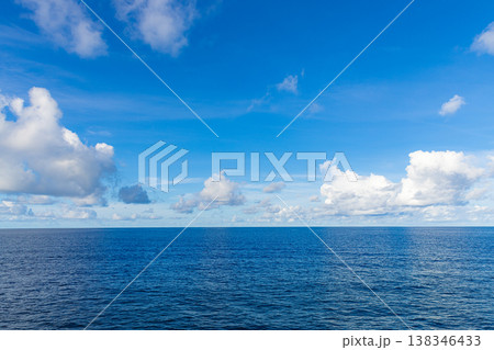 Blue ocean horizon under sunny sky with fluffy clouds, vibrant nature and earth ecology concept background Blue ocean horizon under sunny sky with fluffy clouds, vibrant nature and earth ecology concept background 138346433