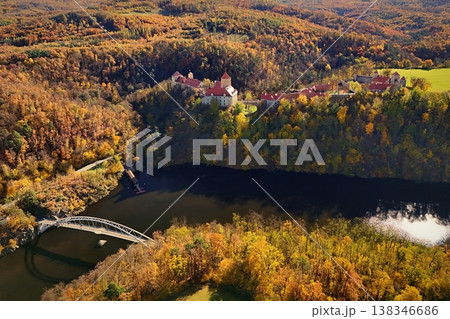 Beautiful autumn landscape with a castle from above from a drone. Beautiful Gothic castle Veveri. The city of Brno at the Brno dam. South Moravia - Czech Republic - Central Europe. Beautiful autumn landscape with a castle from above from a drone. Beautiful Gothic castle Veveri. The city of Brno at the Brno dam. South Moravia - Czech Republic - Central Europe. 138346686