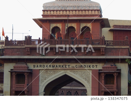 Close-up of the historic red sandstone gate at Sardar Market, Jodhpur, showing intricate balcony details and local design. 138347075