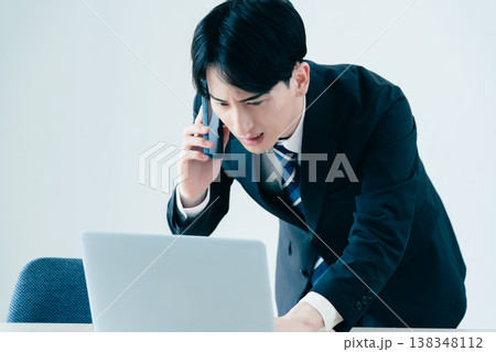 オフィスで電話する若いビジネスマン 138348112