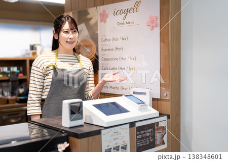 決済端末を案内するエプロン姿の女性 138348601