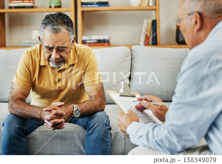 Senior man talking to a therapist at a mental health, psychology and therapy clinic for session. Psychologist with clipboard for counseling checklist with elderly male patient in retirement in office 138349079