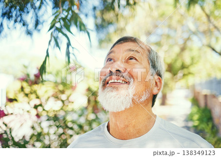 Smile, calm and senior man in nature breathing for fresh air, peaceful or mindful attitude in a garden. Happy, wellness and elderly Asian male person standing in an outdoor park or field in summer. 138349123
