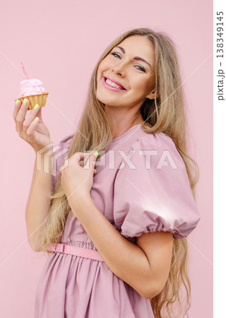 Happy Woman Holding Pink Cupcake With Candle 138349145