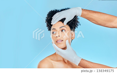 Skincare, plastic surgery and woman with hands on face in studio at cosmetic consultation. Model with spa, facial and filler for beauty, dermatology or collagen therapy on blue background mockup. Skincare, plastic surgery and woman with hands on face in studio at cosmetic consultation. Model with spa, facial and filler for beauty, dermatology or collagen therapy on blue background mockup. 138349175
