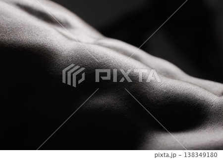 Fitness, black man and torso with abdomen in studio for wellness, stomach and body on dark background. Person, muscle and bodybuilder with six pack for healthy lifestyle or strength and closeup 138349180