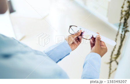 Hands, measuring lens and frame of glasses, person in optometry clinic with eye care, test and healthcare. Eyewear, wellness and prescription with health, spectacles and optometrist with ruler tools Hands, measuring lens and frame of glasses, person in optometry clinic with eye care, test and healthcare. Eyewear, wellness and prescription with health, spectacles and optometrist with ruler tools 138349207
