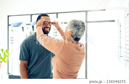 Optometry, glasses and woman with client for decision, choice and options in optician store for vision. Healthcare, ophthalmology and people consulting and prescription lens, spectacles and frames Optometry, glasses and woman with client for decision, choice and options in optician store for vision. Healthcare, ophthalmology and people consulting and prescription lens, spectacles and frames 138349255