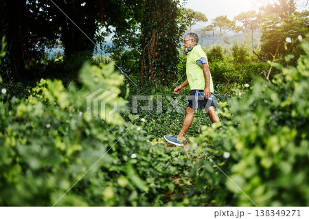 Senior man, fitness walk and forest in profile, green and outdoor for wellness in retirement. Mature person, exercise and workout for health, hiking and freedom in woods, countryside or nature park 138349271