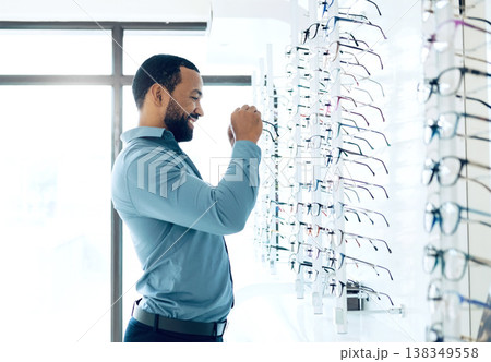 Ophthalmology, glasses and man for eye care decision, choice and options in optician store for vision. Healthcare, optometry and person in clinic to choose prescription lens, spectacles and frames Ophthalmology, glasses and man for eye care decision, choice and options in optician store for vision. Healthcare, optometry and person in clinic to choose prescription lens, spectacles and frames 138349558