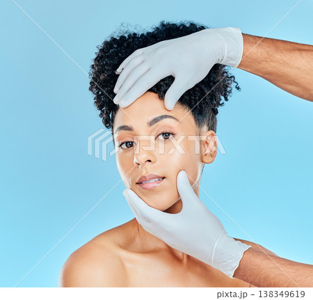 Beauty, plastic surgery and portrait of woman with hands on face in studio for cosmetic facial consultation. Skincare, dermatology and professional collagen therapy, face of model on blue background. 138349619