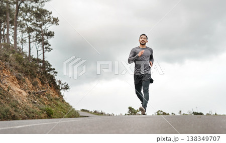 Fitness, exercise and man on road with running, cardio or stamina training in physical activity. Space, practice or athlete on path with jog, outdoor workout and sports endurance in New Zealand. 138349707