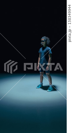 Female teenager athlete with augmented reality visor and data UI overlays in dark minimal studio. Female teenager athlete with augmented reality visor and data UI overlays in dark minimal studio. 138349944