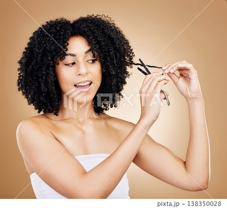 Hair, curls and scissors with woman and beauty, shine and salon treatment with natural cosmetics on studio background. Wellness, haircare and texture with tools for haircut and curly hairstyle 138350028