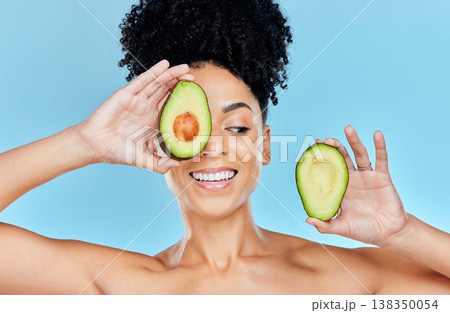 Skincare, avocado and happy woman in studio for cosmetic, wellness and treatment on blue background. Beauty, fruit and female model smile with organic, dermatology or detox for glowing skin routine Skincare, avocado and happy woman in studio for cosmetic, wellness and treatment on blue background. Beauty, fruit and female model smile with organic, dermatology or detox for glowing skin routine 138350054