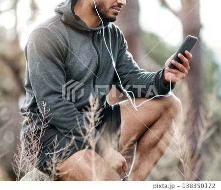 Hands, music and phone with hiker outdoor in nature for break, location tracking or streaming. Earphones, exercise and hiking with male person in forest for fitness, health or wellness activity Hands, music and phone with hiker outdoor in nature for break, location tracking or streaming. Earphones, exercise and hiking with male person in forest for fitness, health or wellness activity 138350172