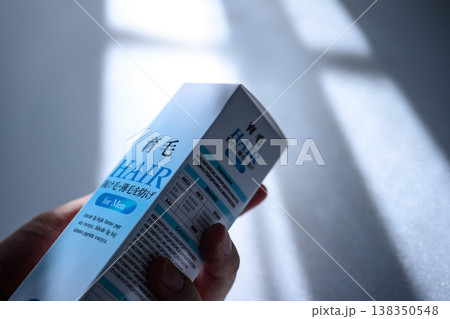 男性用育毛剤の箱を持つ 男性用育毛剤の箱を持つ 138350548