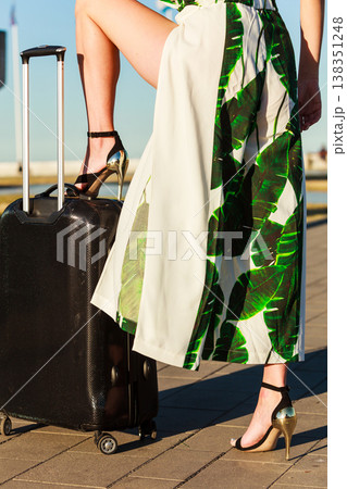 Woman with suitcae on city street Woman with suitcae on city street 138351248