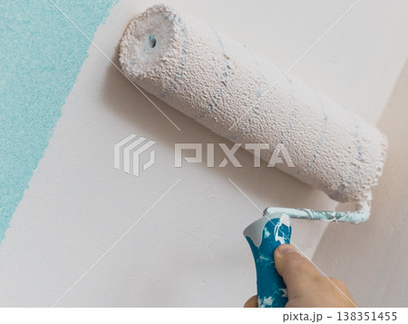 Person applying paint on wall 138351455