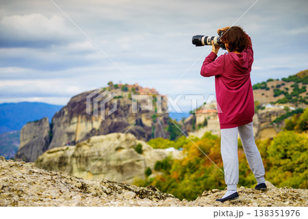 Woman take photo from Meteora monastery Woman take photo from Meteora monastery 138351976