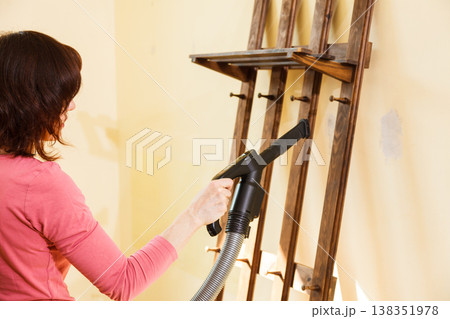 Woman cleaning dust on hanger 138351978