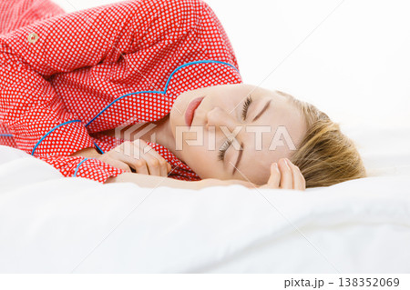 Woman sleeping in bed on the side Woman sleeping in bed on the side 138352069