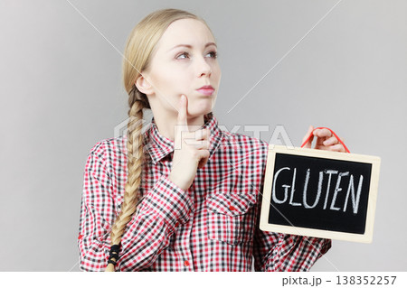 Woman holding board with gluten sign Woman holding board with gluten sign 138352257