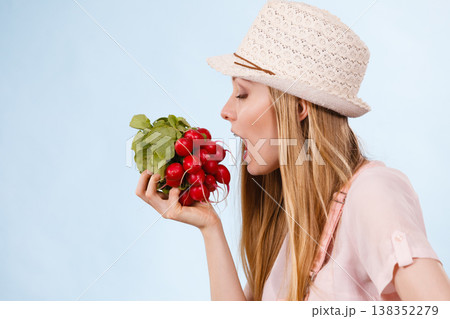 Happy woman holding radish Happy woman holding radish 138352279