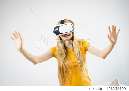 Girl wearing virtual reality goggles. Girl wearing virtual reality goggles. 138352300