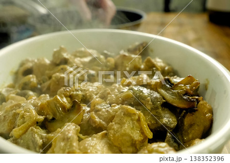Fried pieces of chicken with mushrooms, in milk in a cup Fried pieces of chicken with mushrooms, in milk in a cup 138352396