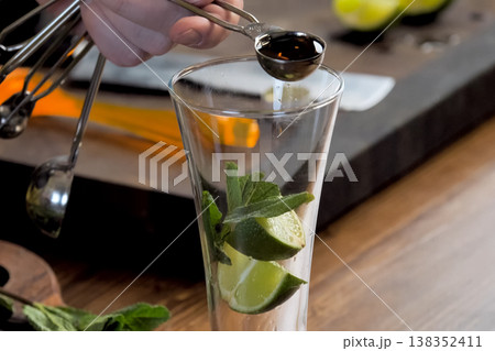 making cocktail of mint and lemon. making cocktail of mint and lemon. 138352411