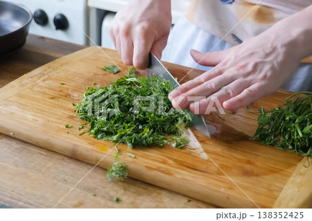 Sliced parsley and dill on board. Greens for the second course. 138352425