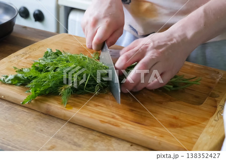 Sliced parsley and dill on board. Greens for the second course. 138352427