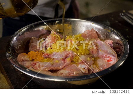 pour chicken meat with sunflower oil. meat 138352432