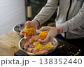 Squeezing lemons in a plate with chicken meat. lemon 138352440