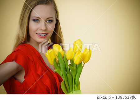 Pretty woman with yellow tulips bunch Pretty woman with yellow tulips bunch 138352706