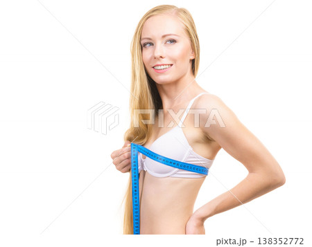 Girl measuring her chest breasts bust size 138352772