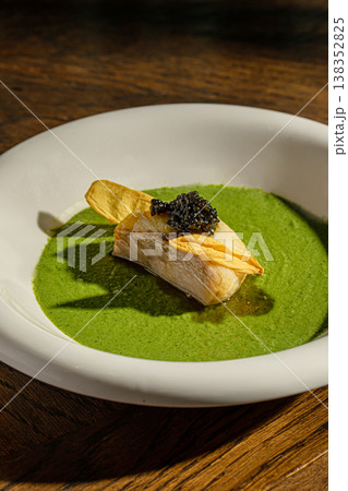 Fish fillet with green sauce and caviar garnish 138352825