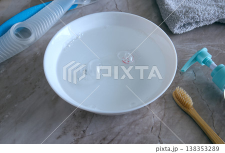 Close-up of a CPAP nasal pillow cushion soaking in a bowl of soapy water for cleaning Close-up of a CPAP nasal pillow cushion soaking in a bowl of soapy water for cleaning 138353289