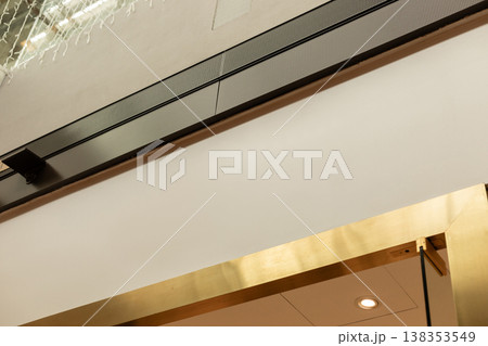 A modern storefront presents an empty space where a logo can be placed. The shop is located in a busy retail area, ready for branding and advertising opportunities A modern storefront presents an empty space where a logo can be placed. The shop is located in a busy retail area, ready for branding and advertising opportunities 138353549
