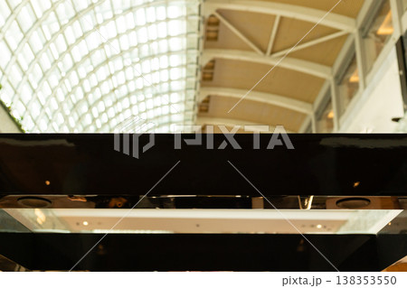 A modern storefront presents an empty space where a logo can be placed. The shop is located in a busy retail area, ready for branding and advertising opportunities 138353550