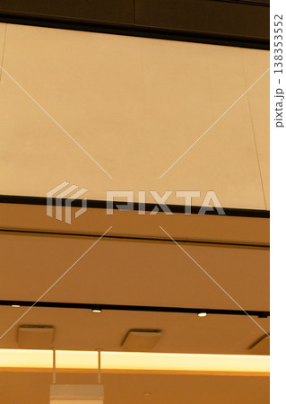 A modern storefront presents an empty space where a logo can be placed. The shop is located in a busy retail area, ready for branding and advertising opportunities A modern storefront presents an empty space where a logo can be placed. The shop is located in a busy retail area, ready for branding and advertising opportunities 138353552