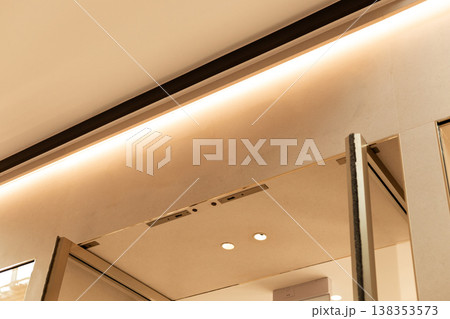 Storefront in a retail area shows an empty space where a logo can be placed. The design features clean lines and a light color scheme. Ideal for various brands and shops Storefront in a retail area shows an empty space where a logo can be placed. The design features clean lines and a light color scheme. Ideal for various brands and shops 138353573