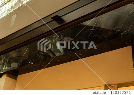 Storefront displays a clean facade with a blank area where a logo can be placed. It is designed for retail businesses. The shop is well lit and provides space for advertising 138353576