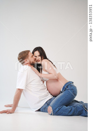 Couple enjoying intimate moment during pregnancy in studio 138353951
