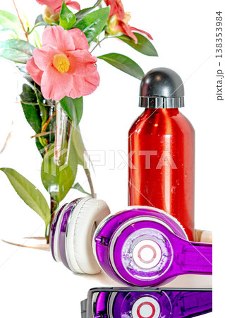 Red bottle and headphones with a flower 138353984