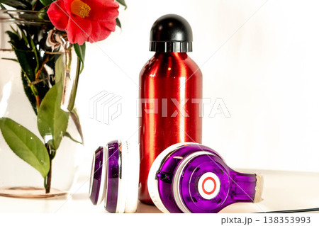 Red bottle and headphones with a flower 138353993