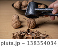 Cracking walnuts with a metal nutcracker tool 138354034