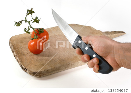 Preparing to slice fresh tomatoes on a wooden chopping board 138354057